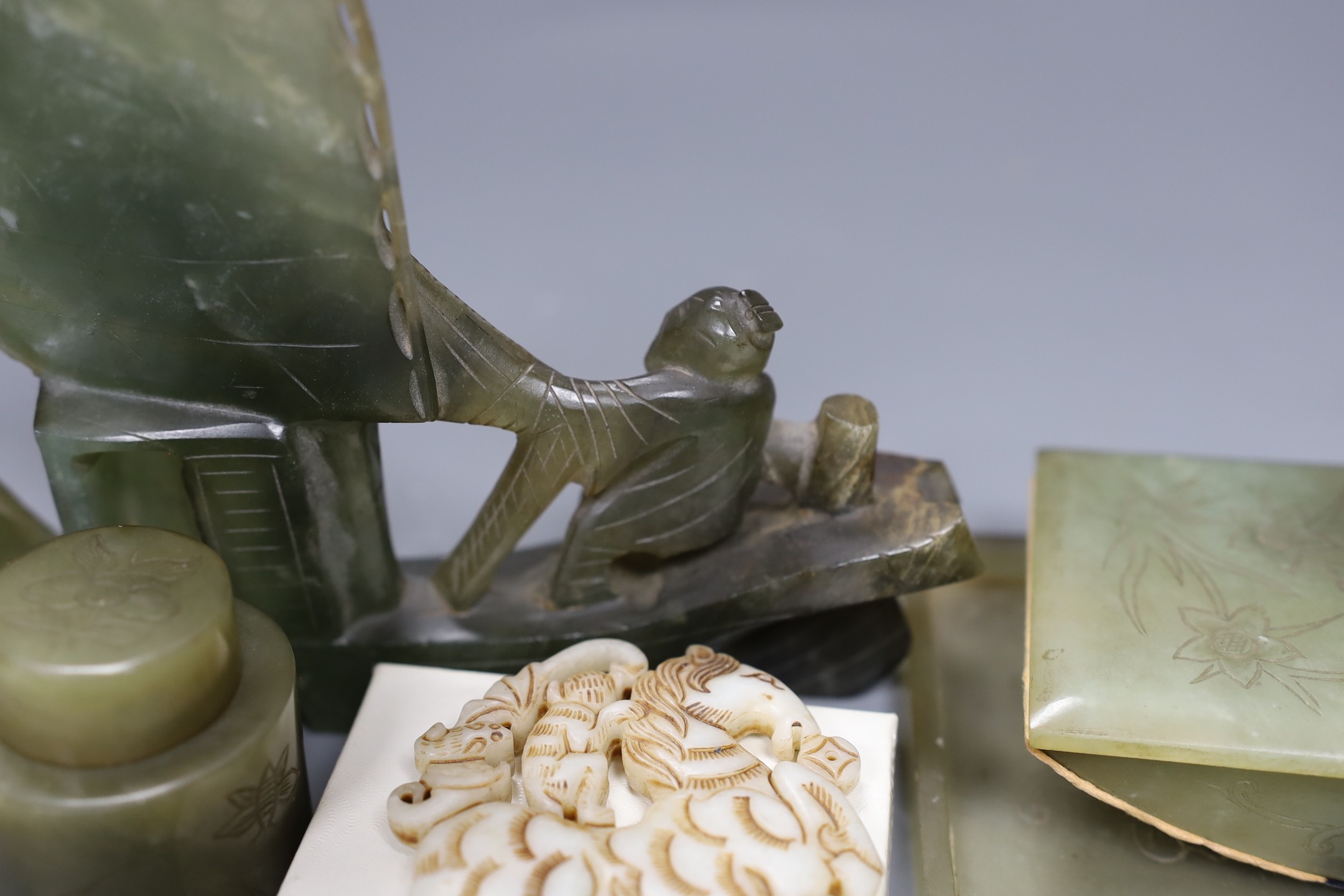 A Chinese bowenite jade desk set (7) and a plaque, model of junk 16cms high